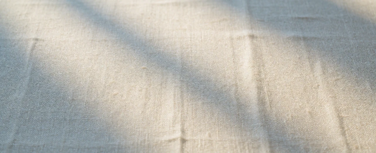 Warm white linen texture in soft farmhouse light for the Farmers Dating contact page